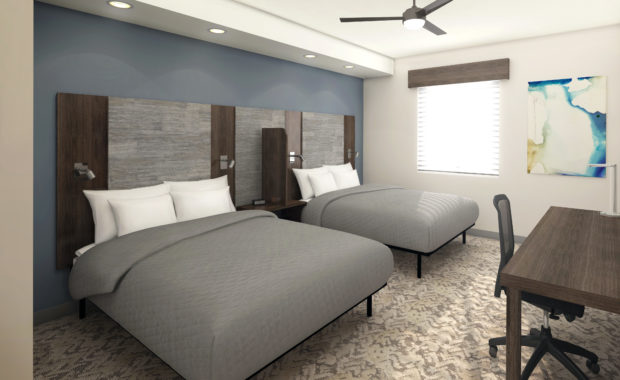 Two queen size beds and desk area in Double Queen Suite