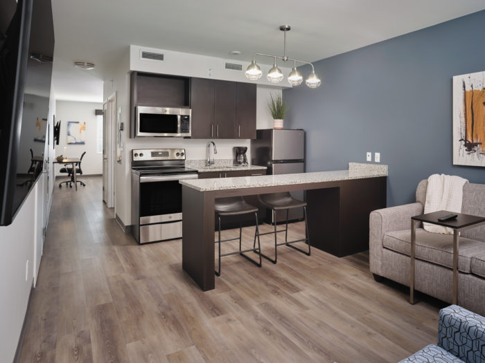 Full-Size Kitchen with Full-Size Appliances, Dedicated Living Room with a Sleeper Sofa, Lounge Chair and 55-inch Smart TV