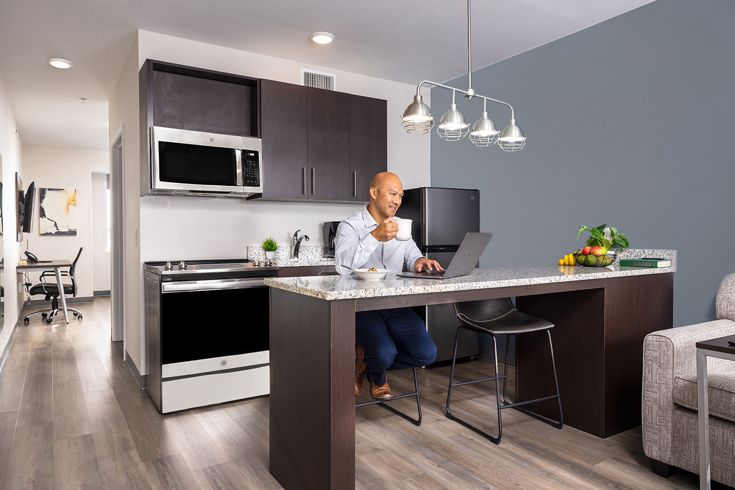 Nurse cooking in stayAPT Suites kitchen