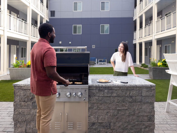 Couple enjoying outdoor grill in courtyard