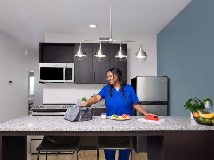 Female nurse in full size kitchen